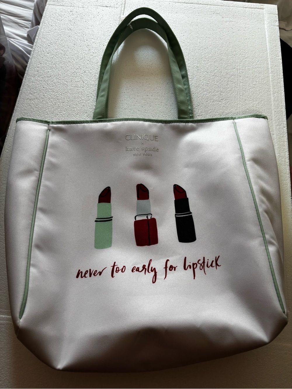 kate spade Silver Tote with Green Trim and Lipstick Graphic
